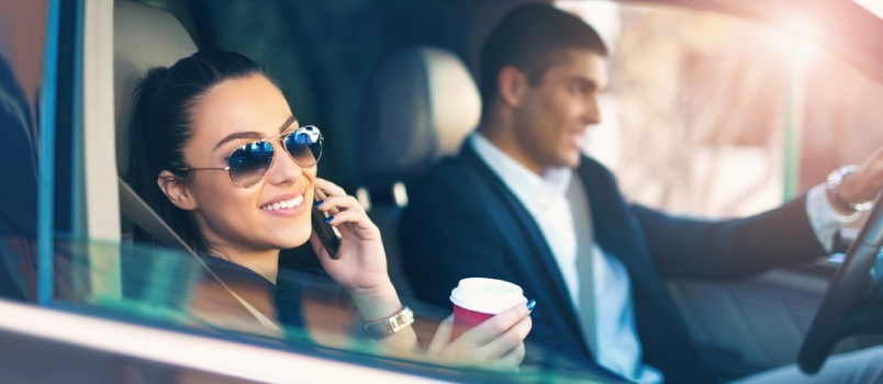 Portrait Of A Pretty Businesswoman And A Coworker Driving A Car