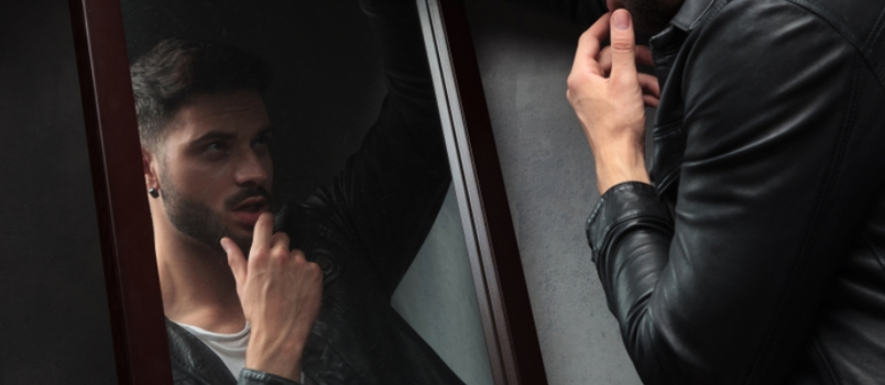 Narcissist Sexy Young Man Admiring Himself In The Mirror And Touches Lips With Fingers