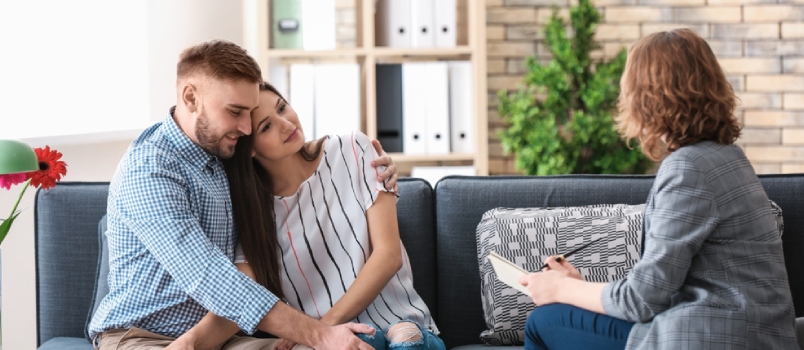 Men And Women In Front Of The Counselor On The Sofa At Her Office Taking Counseling