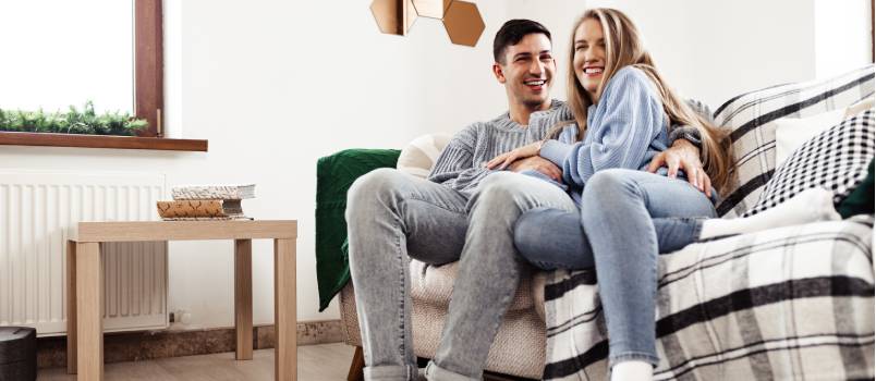 Happy couple sitting on sofa