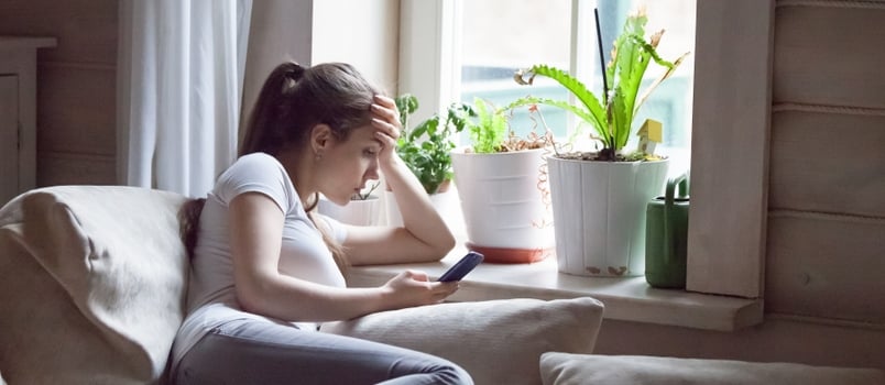 Sad Upset Lady Lying On Bed Wathing On Mobile Phone