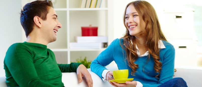 Portrait Of Joyful Friends Looking At One Another While Chatting