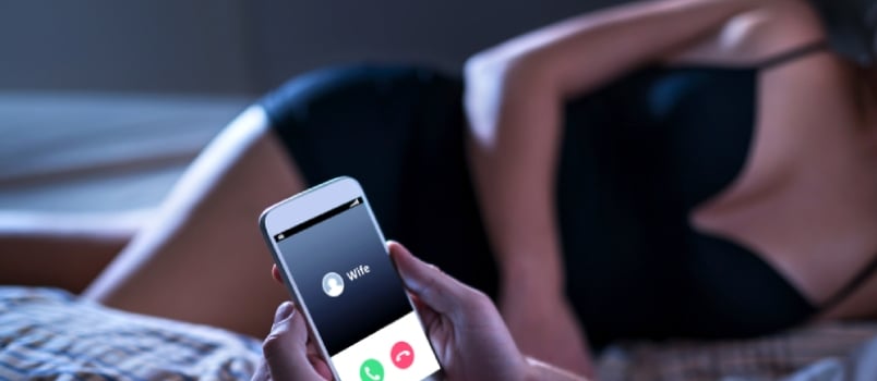 Cheating Unfaithful Man Lying With Mistress In Hotel Bed. Call From Wife To Mobile Phone