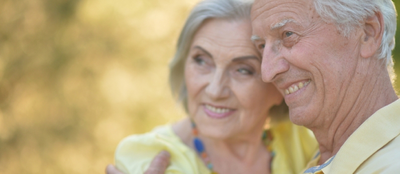 Close Up Portrait Of Beautiful Caucasian Senior Couple Hugging