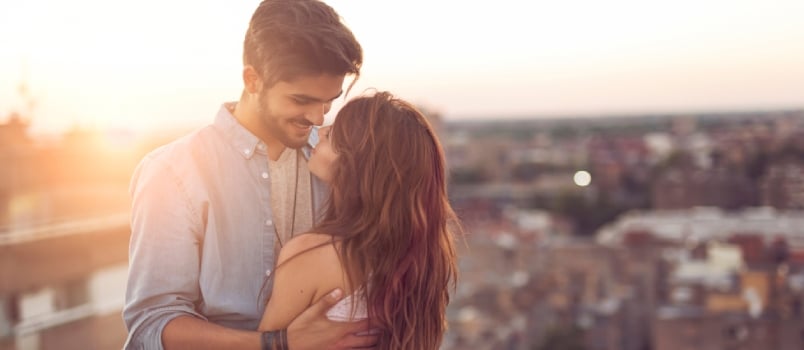 Happy Young Couple Doing Romance On The Floor With City Background