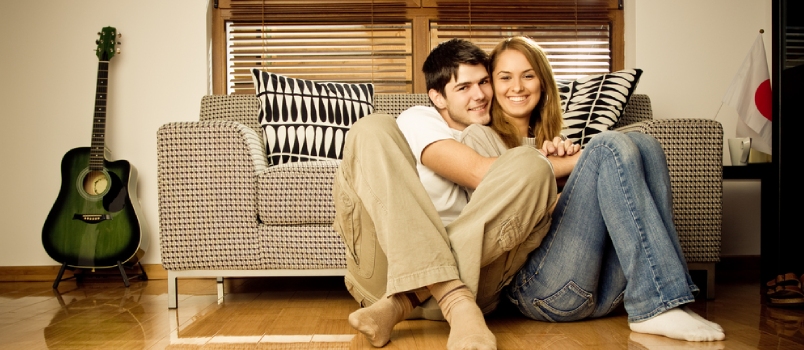 Happy Young Couple Having Fun on the Sofa