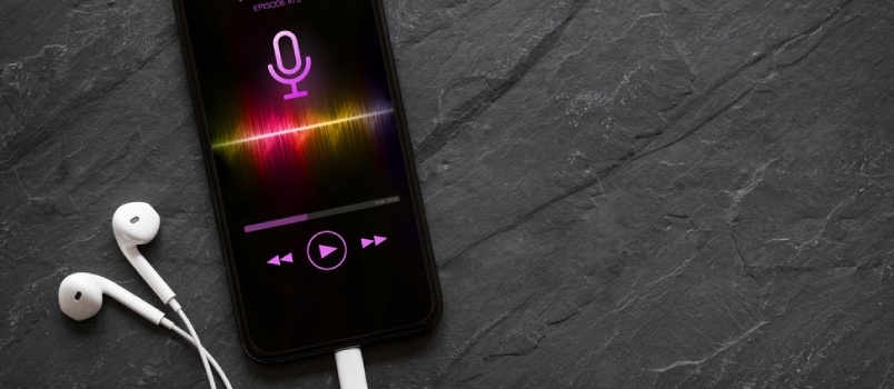 Earphones And Mobile Phone With Podcast App On Screen