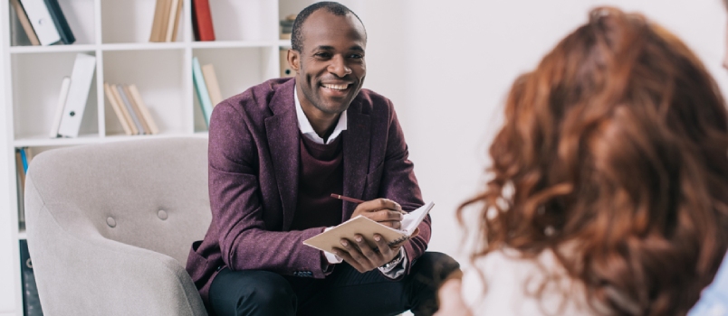 Smiling African American Psychiatrist Talking to Young Couple
