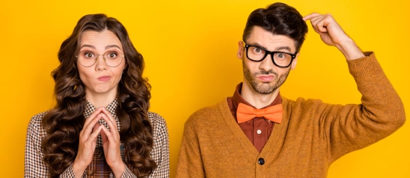 Portrait of Attractive Nervous Confused Couple Thinking Expecting News Isolated Over Bright Yellow Color Background