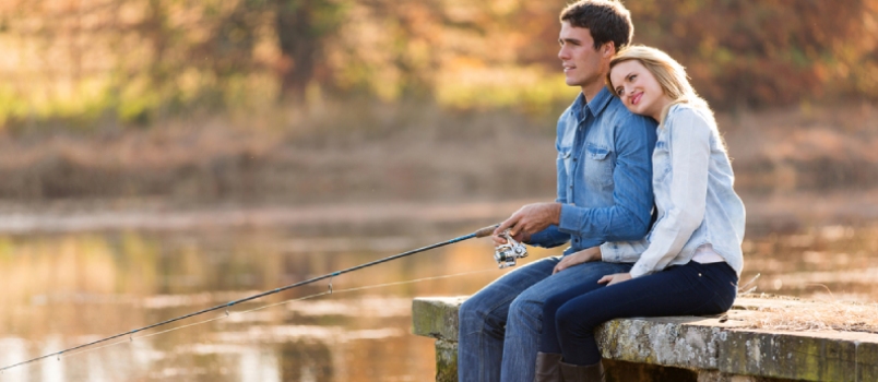 Young Couple Fishing by the Pond in Autumn