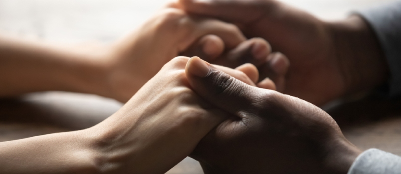 Men and Wome Holding Their Hands Together