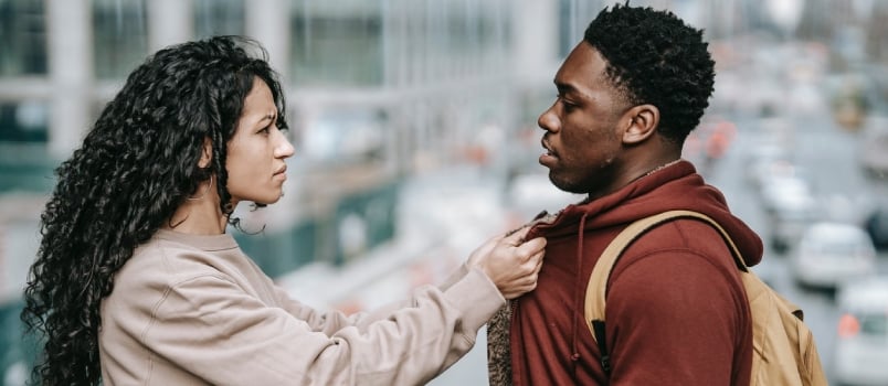 Sad Multiethnic Couple Having Conflict in Street