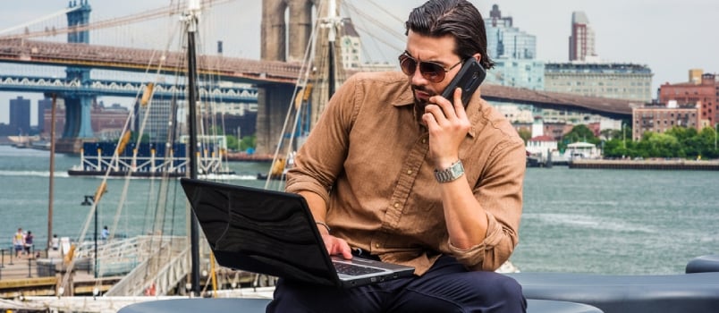 American Business Man Traveling, Working in New York, Wearing Brown Shirt, Sunglasses, Sitting on Bench at Harbor