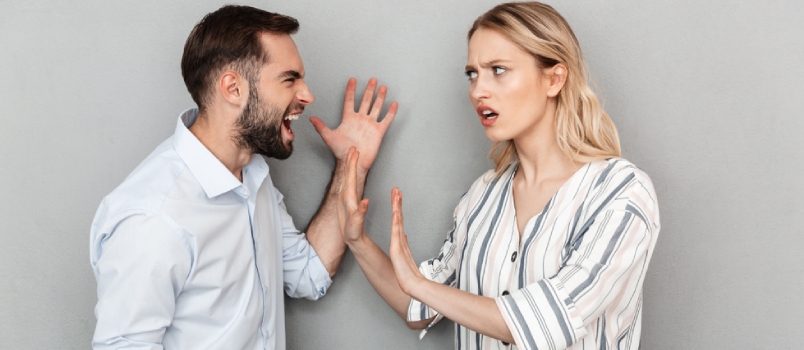 Photo of Irritated Couple Man and Woman in Casual Clothes Having Problems and Arguing Isolated Over Gray Background