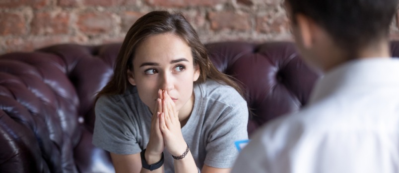 Young Woman Visiting Therapist Counselor. Girl Feeling Depressed, Unhappy and Hopeless, Needs Assistance