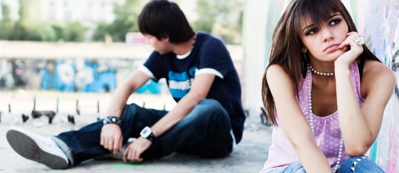 Two Teenagers Apart, Breaking Up, With Graffiti Background