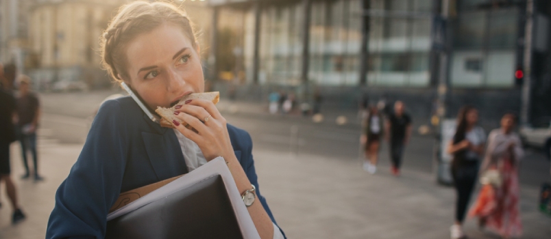Busy Woman Is in a Hurry, She Does Not Have Time, She Is Going to Eat Snack on the Go
