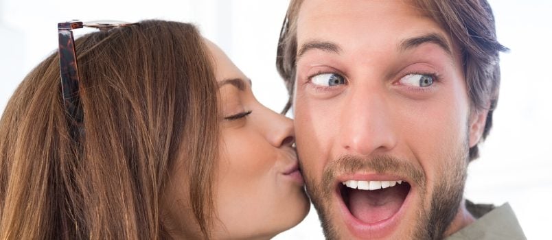 Women Kissing to Men While Men Is Rising His Eyebrow Unconditionally Happiness