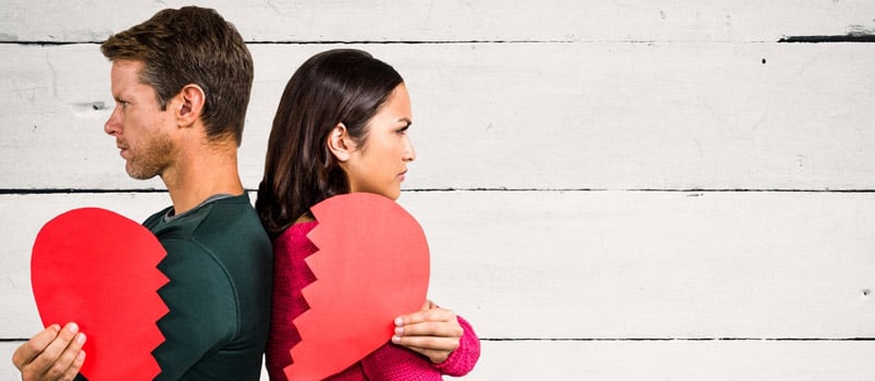 Sad Couple Holding Broken Heart Against Wooden Background