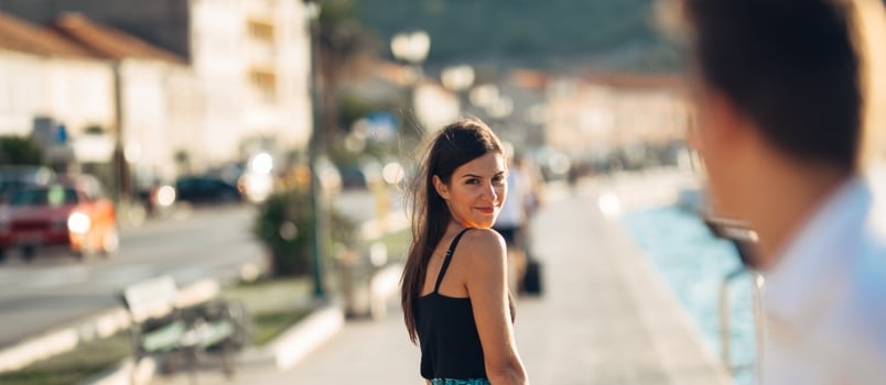 Young Attractive Woman Flirting With a Man on the Street.flirty Smiling Woman Looking Back on a Handsome Man.female Attraction