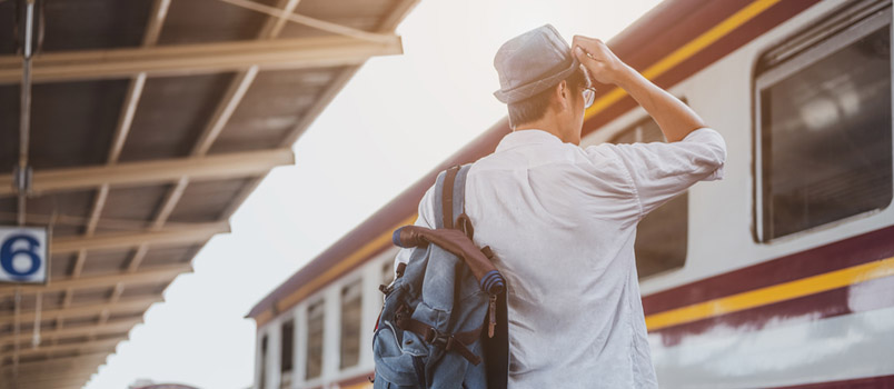 Asian Man Traveler With Backpack Waiting for Train, Asian Backpacker With Hat Standing on Railway Platform at Bangkok Train Station