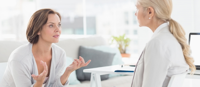 Young Woman Talking With Her Therapist in Office