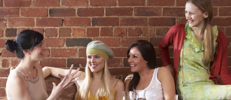 Young Women Sitting Together and Talking