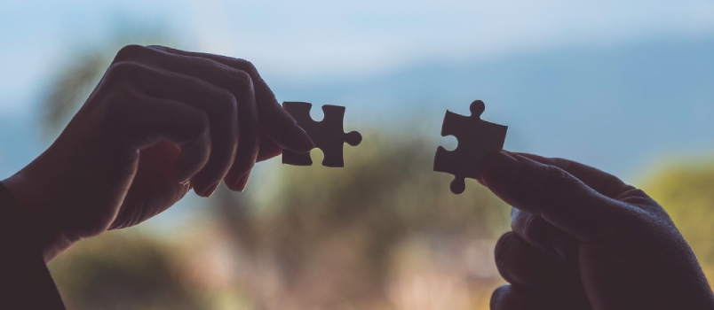 Closeup Image of Two Hands Holding a Jigsaw Puzzle With Feeling Love