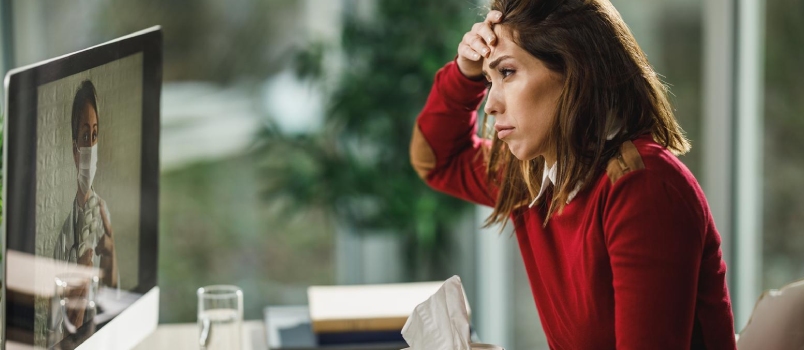Young Sad Woman in Working on Tablet Sitting on the Couch