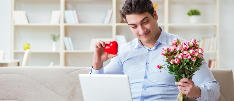 Young Man Making Marriage Proposal Over Internet Laptop