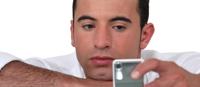 Man Watching on Phone Waiting for Someone Call