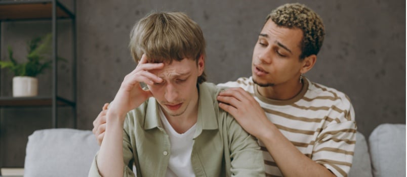 Man comforting another man