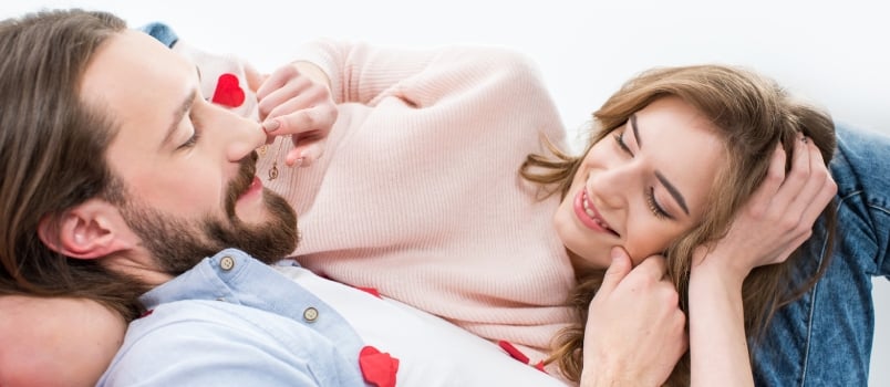 Beautiful Happy Couple in Love Lying and Touching Each Other