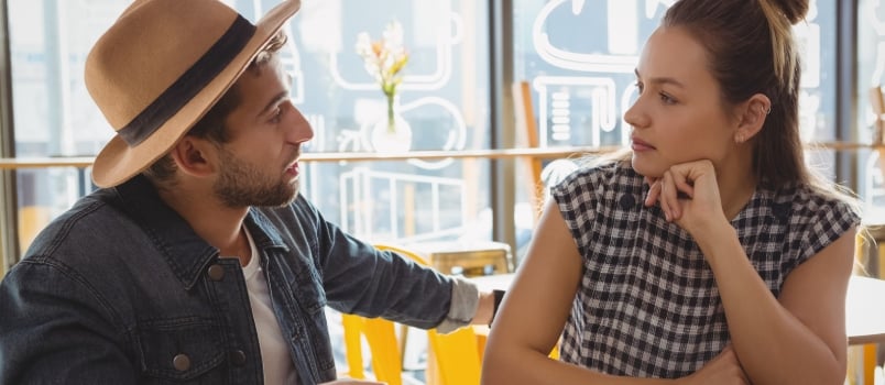 Young Couple Talking at Table in Cafe
