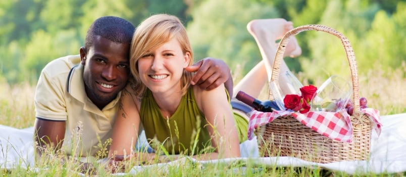 Portrait of Young Multiethnic Couple Picnicking in Park