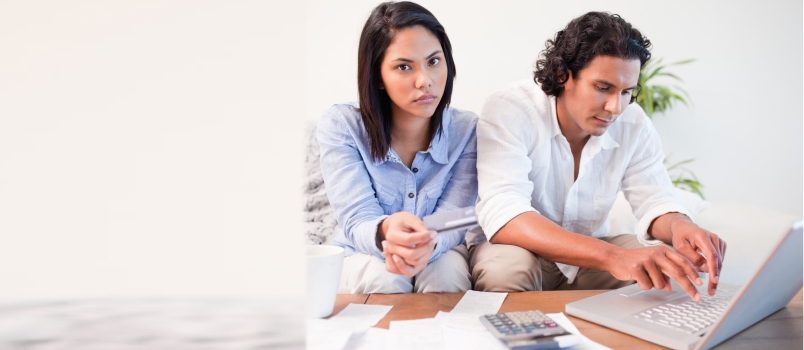 Young Couple Checking Their Bank Accounts Online in the Living Room