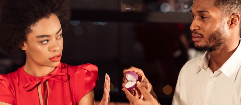 Black Millennial Girl Rejecting Saying No to Boyfriend's Marriage Proposal Refusing to Take Engagement Ring in Restaurant