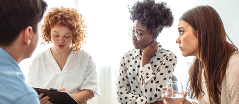 Support Group Gathering for a Meeting. Young Woman Discussing With People at Entrance Hall