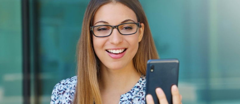 Portrait of Young Woman Outdoor Making a Video Call Using Smart Phone.
