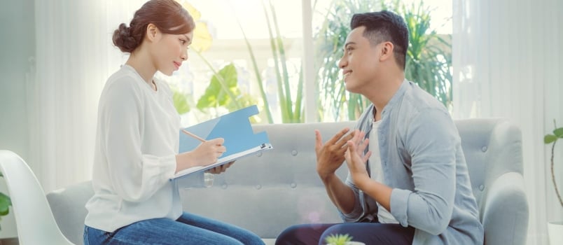 Young Man Counseling With His Doctor at Her Office