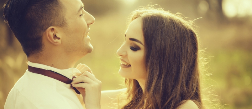 Young Happy Wedding Couple of Pretty Woman and Man Undressing in Field Outdoor