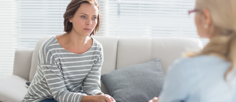 Woman Talking to Her Therapist on Sofa at Home