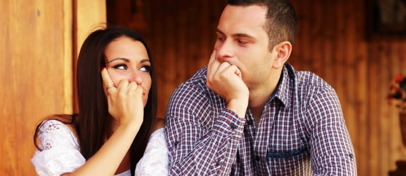 Young Thinking Couple Looking at Each Other