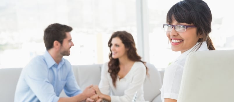 Reconciled Couple Smiling at Each Other in the Therapist Office
