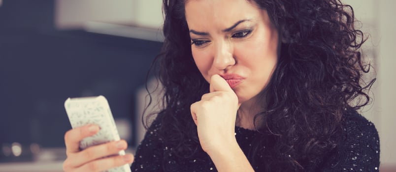 Upset Confused Young Woman Suing Mobile Phone Reading Text Message