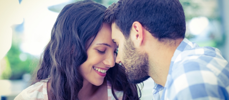 Cute Couple Putting Foreheads Against Each Others at the Cafe
