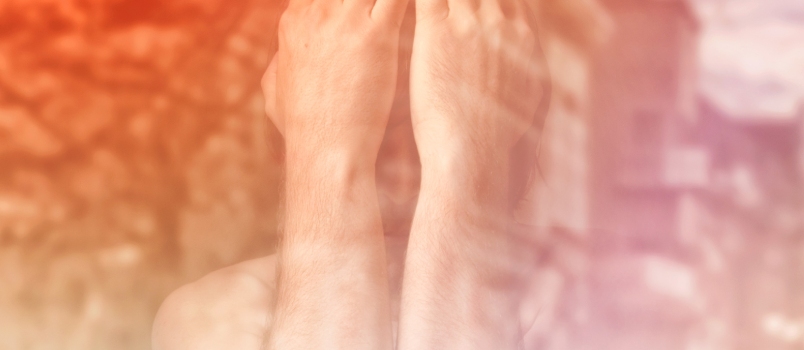 Sad Man Is Covering His Face With Hands and Crying in Despair, Double Exposure Image With Unrecognizable People Walking on Street.