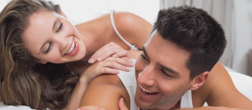 Close Up Portrait of Romantic Young Couple in Bed at Home