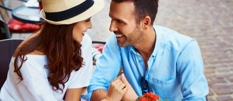 Couple in Love Sitting in Cafe Looking at Each Other