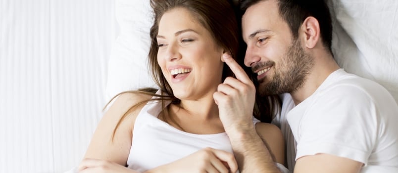 White Couple Having Fun One the Bed